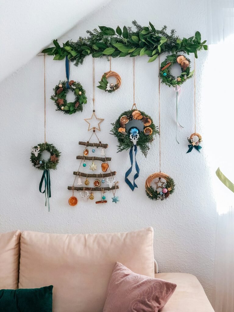a living room with a couch and a christmas tree hanging  on the wall