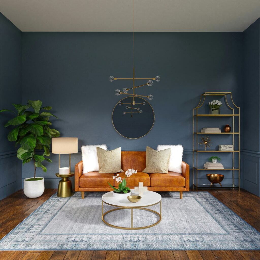 A small room with deep blue walls, a tan leather sofa, gold shelving, and a light rug adding balance and brightness