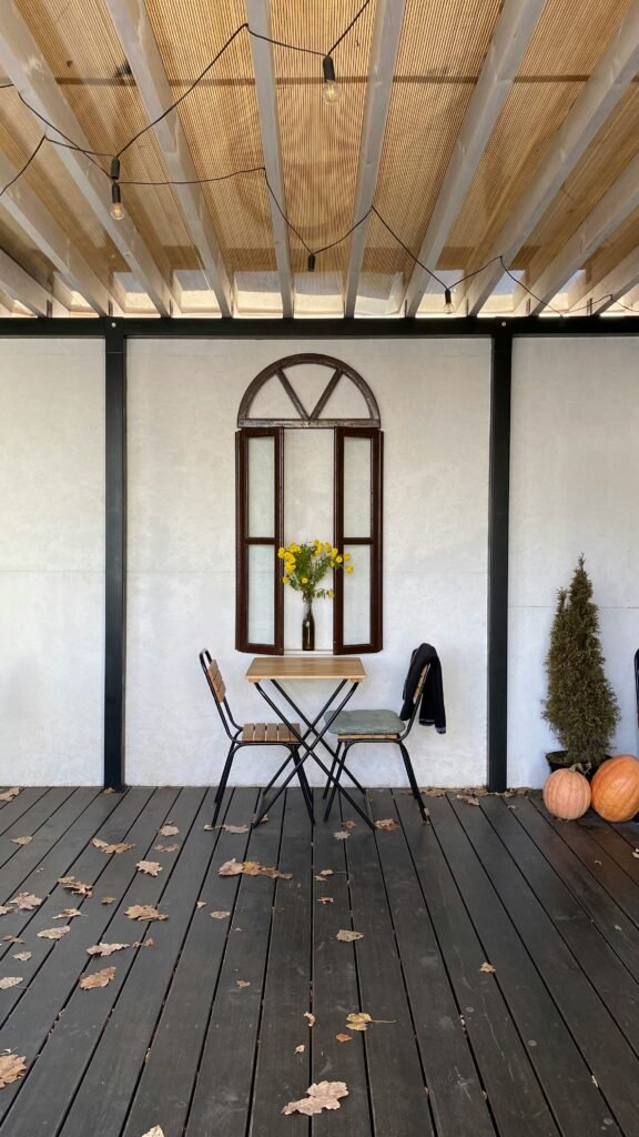 a wooden deck with chair and table DIY Décor Projects